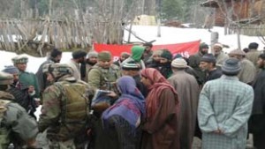 Army personnel distributing blankets among needy people at Rafiabad in Srinagar on Sunday.