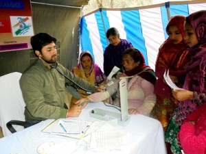 Doctor examining patient during medical camp at village Dradhu in tehsil Bhaderwah. -Excelsior/Tilak Raj
