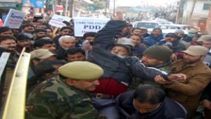 Police detaining PDD employees at Srinagar during protest. Excelsior/ Tariq Mir