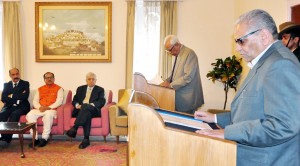 Governor N N Vohra administering oath to Mohammad Shafi Uri as Pro-tem Speaker in Raj Bhawan on Friday.