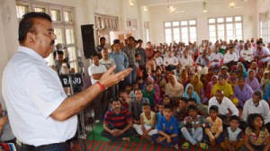 Minister for Industries and Commerce, Chander Parkash addressing a gathering during an awareness camp at Dolian on Saturday.