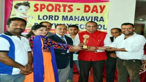 Memento being presented to the chief guest during Annual Sports Day at Lord Mahavira Playway School in Jammu.