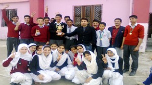 Winners of the Cricket Tournament holding trophy while posing for a group photograph at Cosmopolitan Public School at Sidhra in Jammu. 