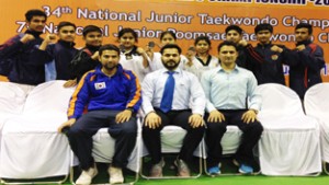 State Taekwondo players posing along with officials after excelling in National Championship.