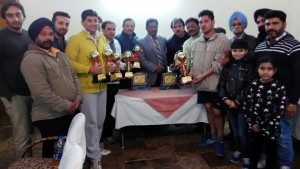 Winners of Squash titles posing along with dignitaries in Jammu.