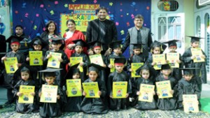 Dignitaries and children of Apple Kids School Bakshi Nagar posing for a group photograph on Wednesday.