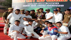 Jubilant players of Tanishta Cricket Club holding title trophy while posing for a group photograph along with chief guest and other dignitaries in Jammu on Wednesday.