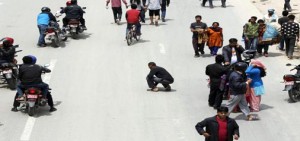 A man sits in the middle of the road during a strong aftershock after an earthquake in Kathmandu on Sunday. (UNI)