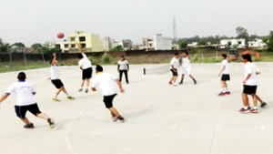  Students displaying skill during a basketball match at JP World School in Jammu. 