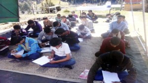 Students appearing in slogan writing competition orgainzed by Army at Channi in Bhaderwah.