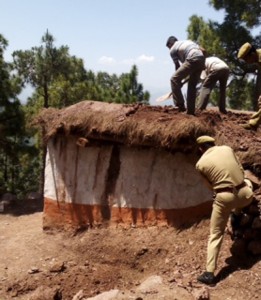 A joint team of Forest Department and Forest Protection Force assisted by police dismantling an illegal strucutre.