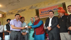 Deputy Chief Minister, Dr Nirmal Singh felicitating winners and dignitaries during Baisakhi Mela on Monday. 