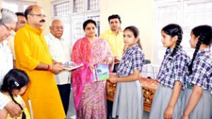 Minister of State for Information, Education and Culture, Priya Sethi distributing books among orphans in Jammu on Thursday.