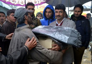 BJP leader distributing relief material among landslide affected families in Baramulla on Wednesday.