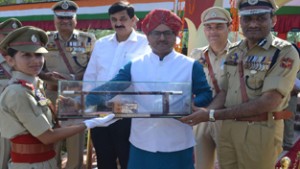 Dy Chief Minister, Dr Nirmal Singh awarding a pass-out at Sher-i-Kashmir Police Academy on Wednesday. 