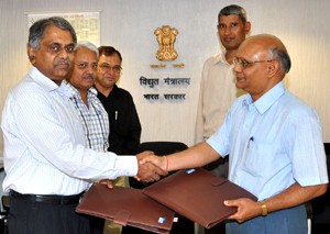 RST Sai, CMD, NHPC, exchanging documents with PK Sinha, Secretary, Union Ministry of Power, after signing MoU between NHPC and Union Ministry of Power, at New Delhi.