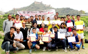 Winners of Spring Champions Run displaying certificates while posing for a group photograph.  