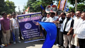Minister for Forest, Bali Bhagat flagging off rally to pay homage to Dr B R Ambedkar at Jammu on Sunday.