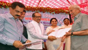 Deputy Chief Minister Dr Nirmal Kumar Singh and MoS Education Priya Sethi presenting building permission letter to an applicant during Mela on Friday.