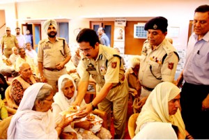 DIG, Shakeel Ahmed Beig serving refreshment to inmates of Old Age Home at Jammu.