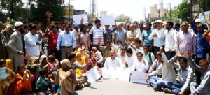 JKNPP activists along with families of Latti bus accident victims protesting at Udhampur on Saturday.