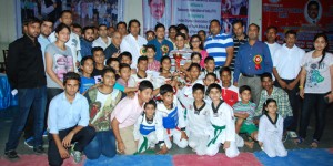 Winners posing along with the dignitaries during valedictory function of Taekwondo Championship at MA Stadium in Jammu on Sunday.