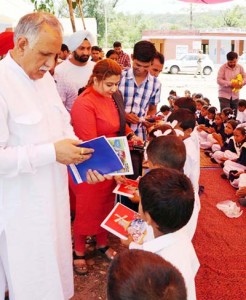 MP Shamsher Singh Manhas and Aditi Sharma distributing books among students on Monday.