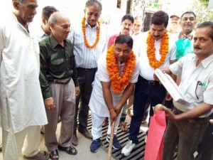 MLA Jammu West Sat Sharma digging ground to launch construction of deep drains in Bhagwati Nagar on Monday.