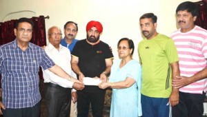 Chairman JKCA Arvinder Singh Micky, former chairman, Romesh Mahajan, member BCCI, Ankush Abrol and other dignitaries presenting a cheque of Rs 2 lakh to the family of Late Barjinder Singh.        