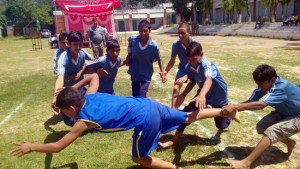 Raider making valiant effort to touch the line while catcher leaving no stone unturned in getting hold of him during a kabaddi match at Pouni in Reasi.   