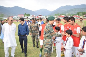 Army officers interacting with young footballers during inaugural function of Shaheed Major Gopi Singh Rathore Football Tournament at Bandipora on Saturday. -Excelsior/ Aabid Nabi