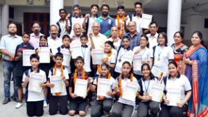 Medalists of Speedball Nationals displaying certificates while posing for a group photograph along with dignitaries and officials in Jammu.