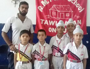 Winners of Wushu competition posing along with team in-charge at RMPS in Jammu.