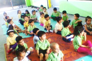 Children performing Yoga at Peepal Tree School in Jammu on Saturday.