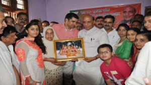 Sheela Baru presenting a memento of Mata Vaishno Devi to Union Home Minister, Rajnath Singh at her residence at Talab Tillo on Wednesday.