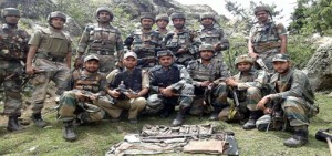 Troops pose with recoveries made in Arnas on Thursday.