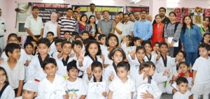 Taekwondo belt grading examination qualifiers posing for group photograph. 