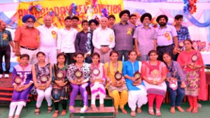 Students of Arvind Ghosh HSS Vijaypur posing for a group photograph along with chief guest and other dignitaries while celebrating Annual Day.