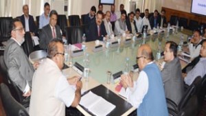 Minister for Finance, Dr Haseeb A Drabu chairing an officers meeting at Srinagar on Wednesday.