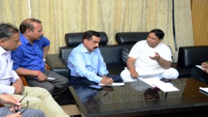 MLA Jammu West Sat Sharma with JMC Commissioner during a meeting on Tuesday.