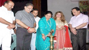 Assembly Speaker Kavinder Gupta and MoS Priya Sethi lightening lamp during a function in Jammu on Sunday.