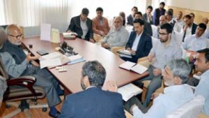 Minister for Education, Naeem Akhtar chairing a meeting at Srinagar on Wednesday.