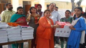 Social activist Aditi Sharma distributing stationery items among girl students on Wednesday.