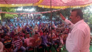 Minister of Industries & Commerce Chander Parkash Ganga addressing a public meeting at Patti on Saturday. 