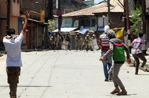 Youth hurling stones at security forces during protests at Nowhatta area in old city of Srinagar on Saturday. — Excelsior/Amin War
