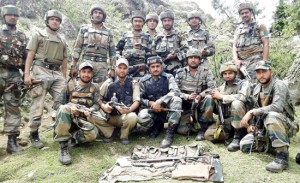 Army personnel pose with recoveries made in Nowshera sector on Saturday. 
