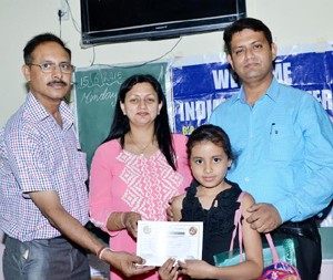 Winner receiving certificate from dignitaries.