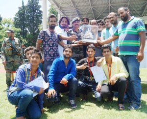 Winners of Shaheed Major Rohit Sharma T-20 Cricket Tournament receiving title trophy from dignitaries.