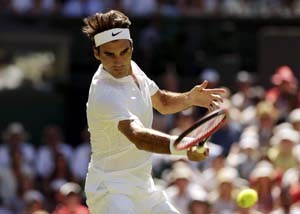  Roger Federer of Switzerland hits a shot during his match against Damir Dzumhur of Bosnia and Herzegovina at the Wimbledon Tennis Championships in London