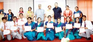 Students posing for photograph after receiving certificates and medals during annual prize distribution function by MIER College of Education.